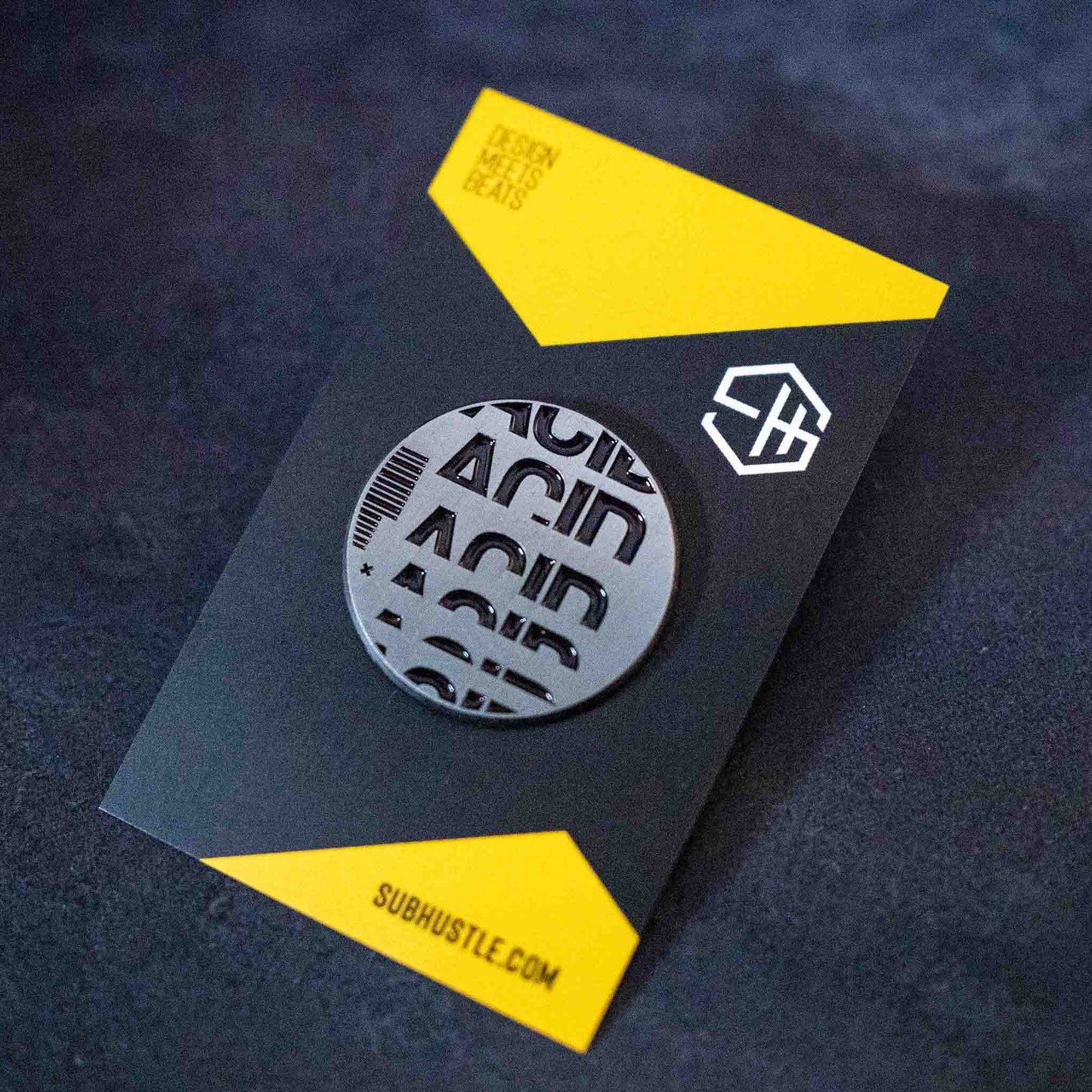 Antique silver with black enamel acid house pin badge on backing card