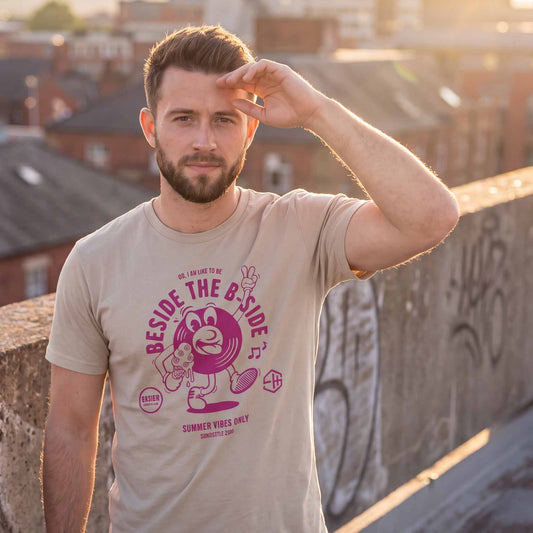 Man wearing a dust summer vibes t-shirt with a graphic design outside