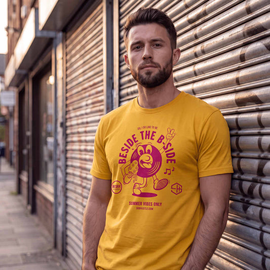 Man wearing a yellow summer vibes t-shirt with a graphic design outside