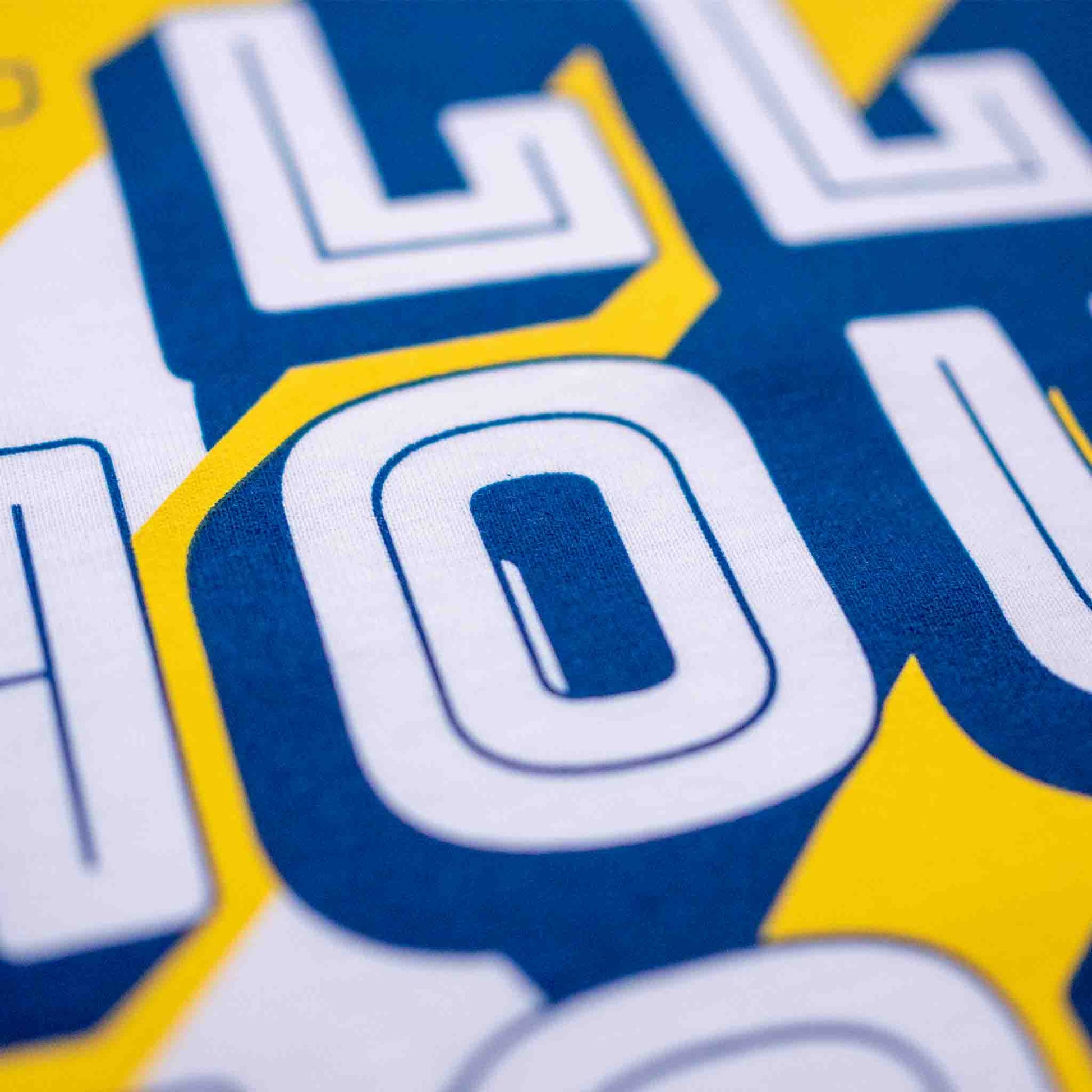 Closeup of the navy blue and yellow screenprinted t-shirt
